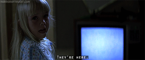 GIF of the girl from the Shining saying "They're here..."
