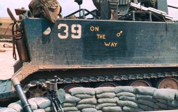 A close up of a tank's markings, which read: "39 On The Way" with a Mars/male symbol.