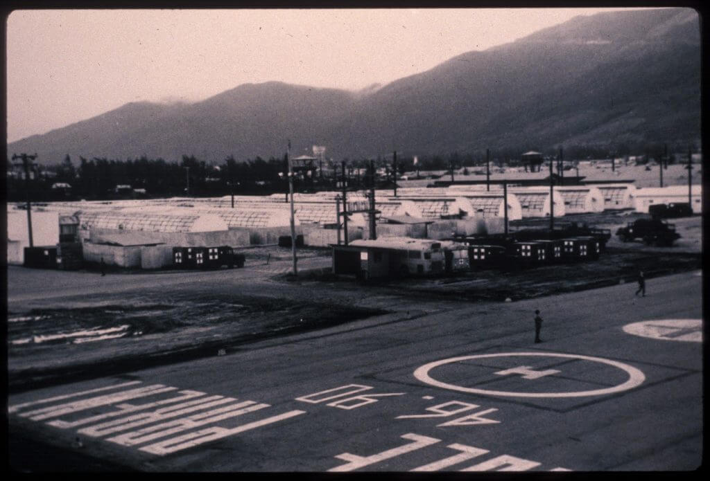 95th Evacuation Hospital and landing pad with mountains in the background.