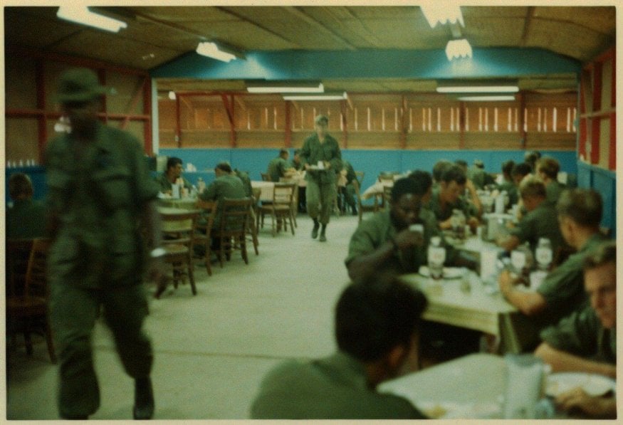 Soldiers eating in a dining room.