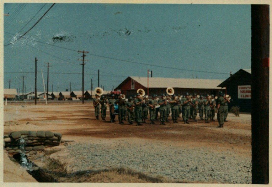 Army band playing outside an encampment.