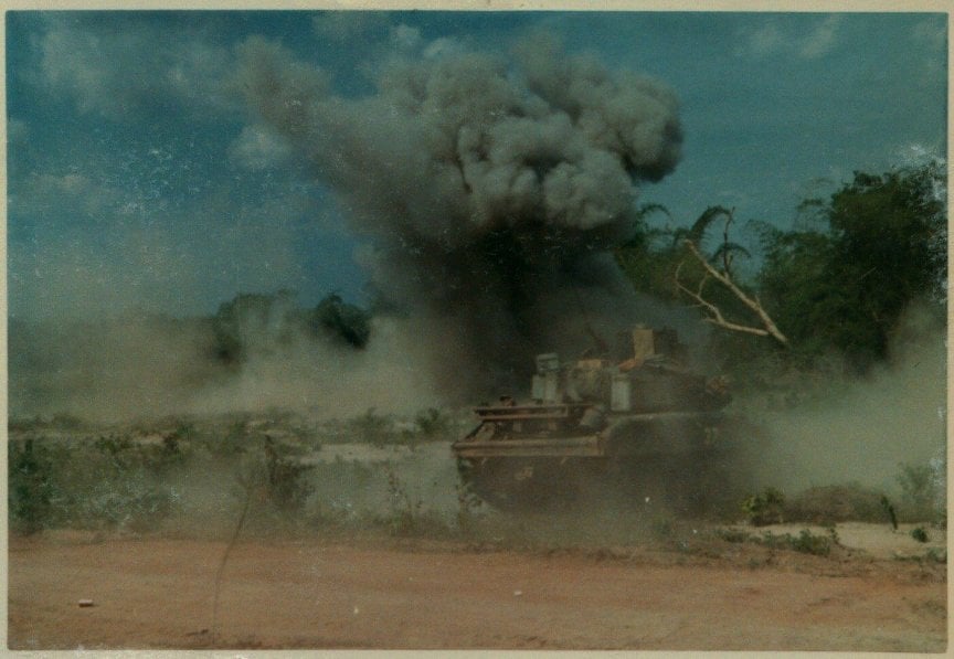 Tank in the foreground, explosion in the background.