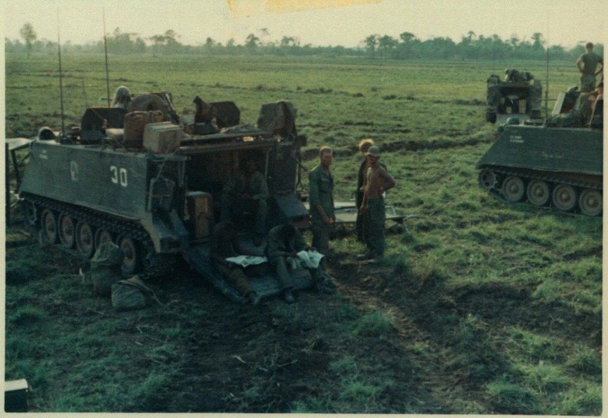 Tanks and U.S. soldiers in a field.