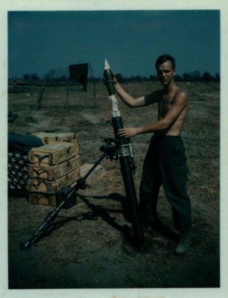 Young U.S. soldier holding a mortar and launcher.