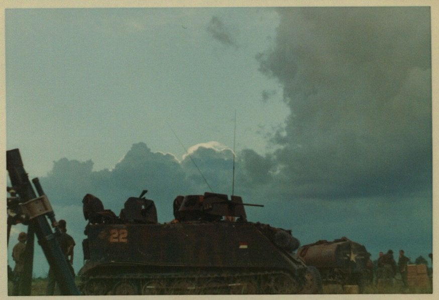 Tanks against a cloudy sky.