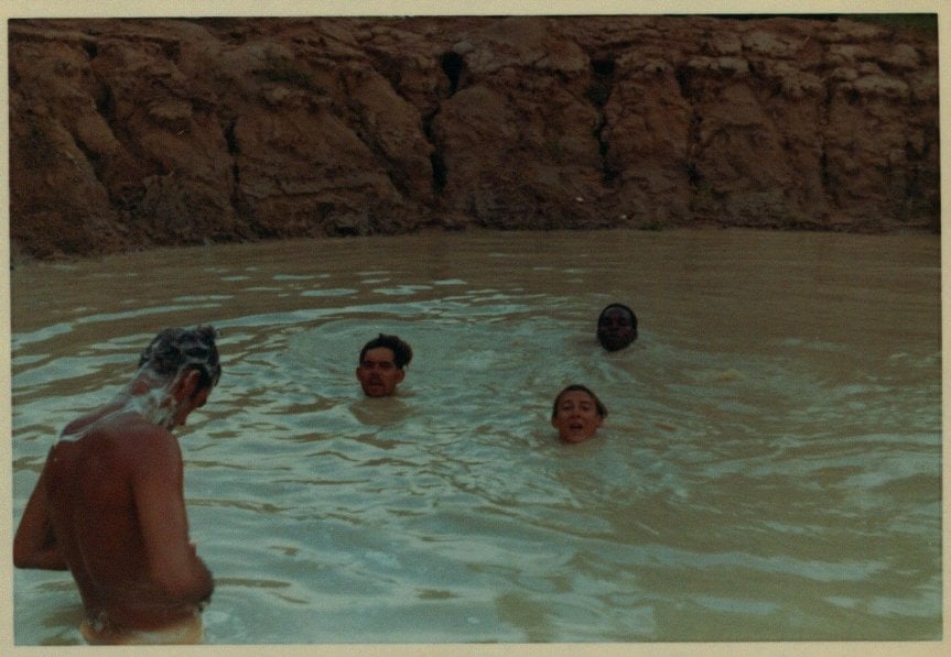 Soldiers bathing in a small body of water.
