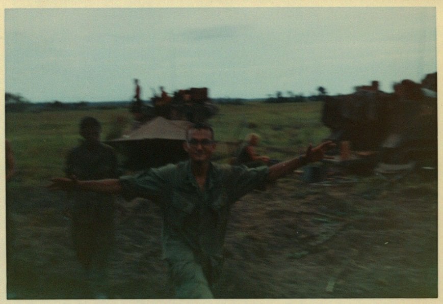 Soldiers and tanks in a field.