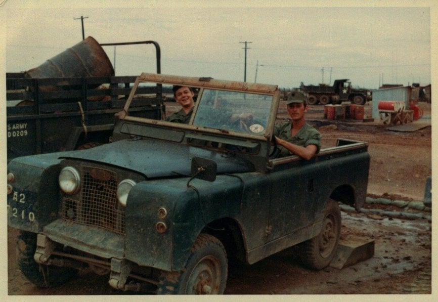 Two soldiers in a jeep.