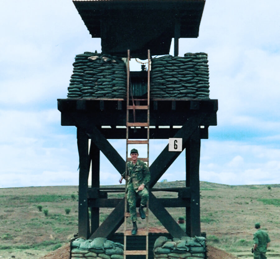 Soldier in a ladder leading up to a watchtower.