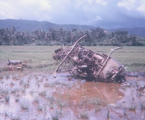 Crashed helicopter in a swampy area.