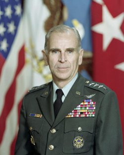 Official contemporary military portrait of an older, very decorated general, American flag in the background. Photo courtesy of Wikimedia Commons.