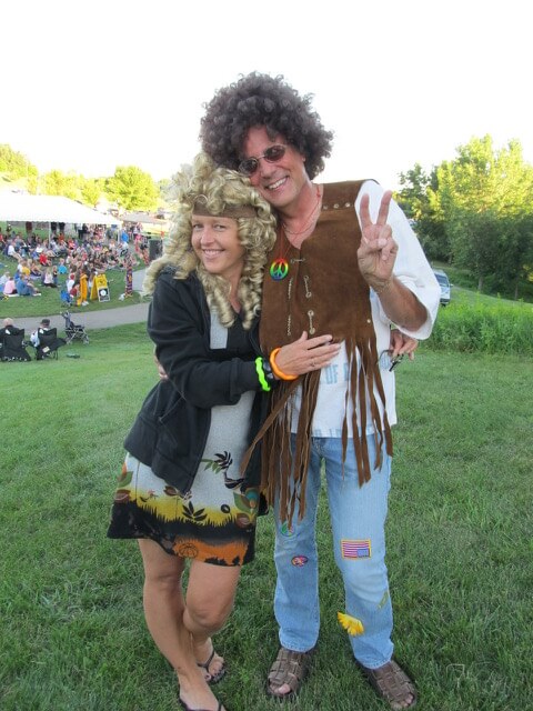 Contemporary photo of a man and woman dressed in hippie costumes.