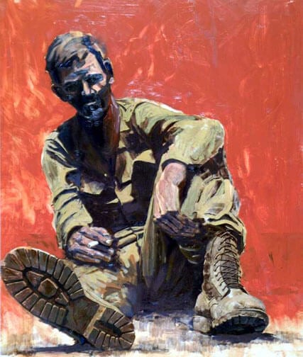 A weary looking soldier, slumped against a red wall, cigarette in hand.