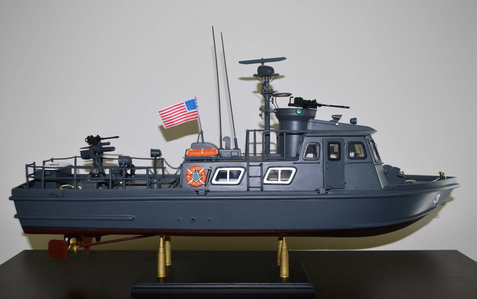A model replica of a swift boat, American flag waving.