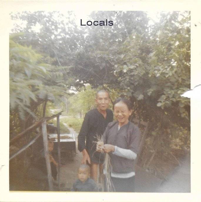 Older Asian couple and an infant. Text says: "Locals."