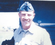 A close up of a pilot, smiling.