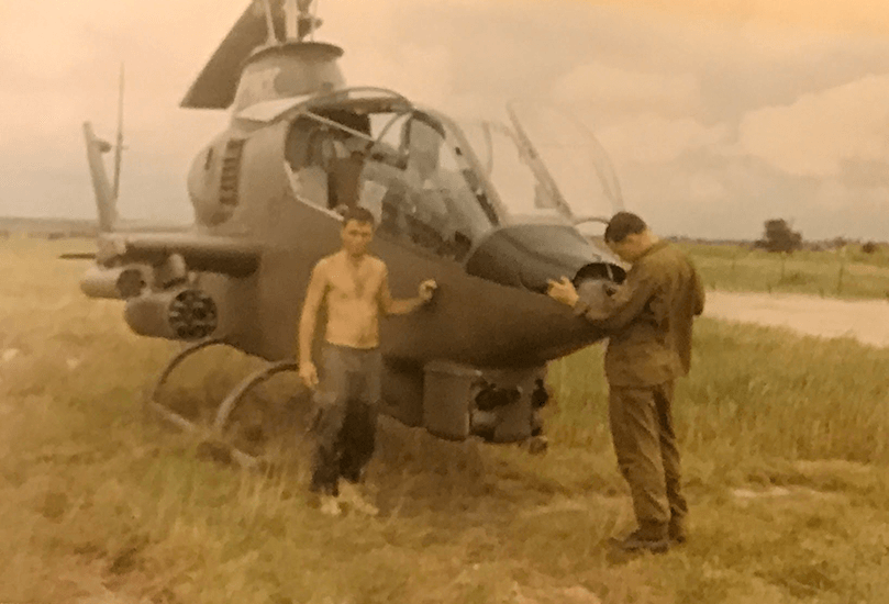 Two U.S. soldiers with a helicopter.
