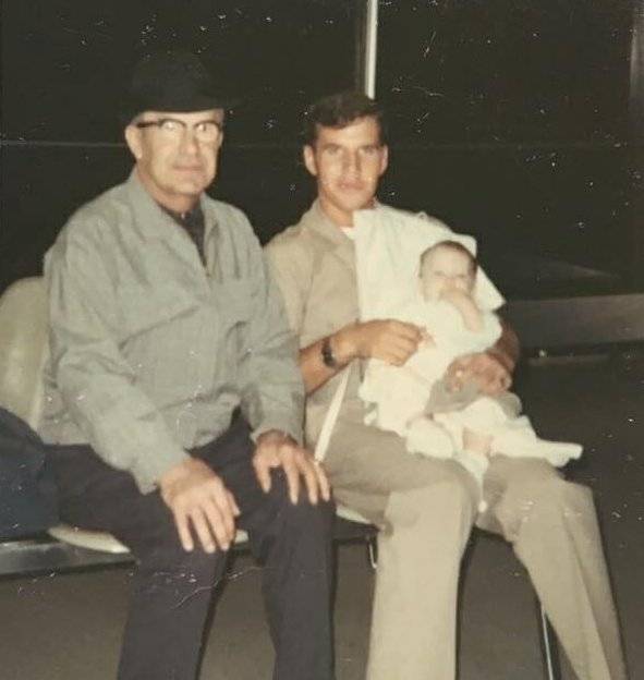 An older man, young man, and infant.
