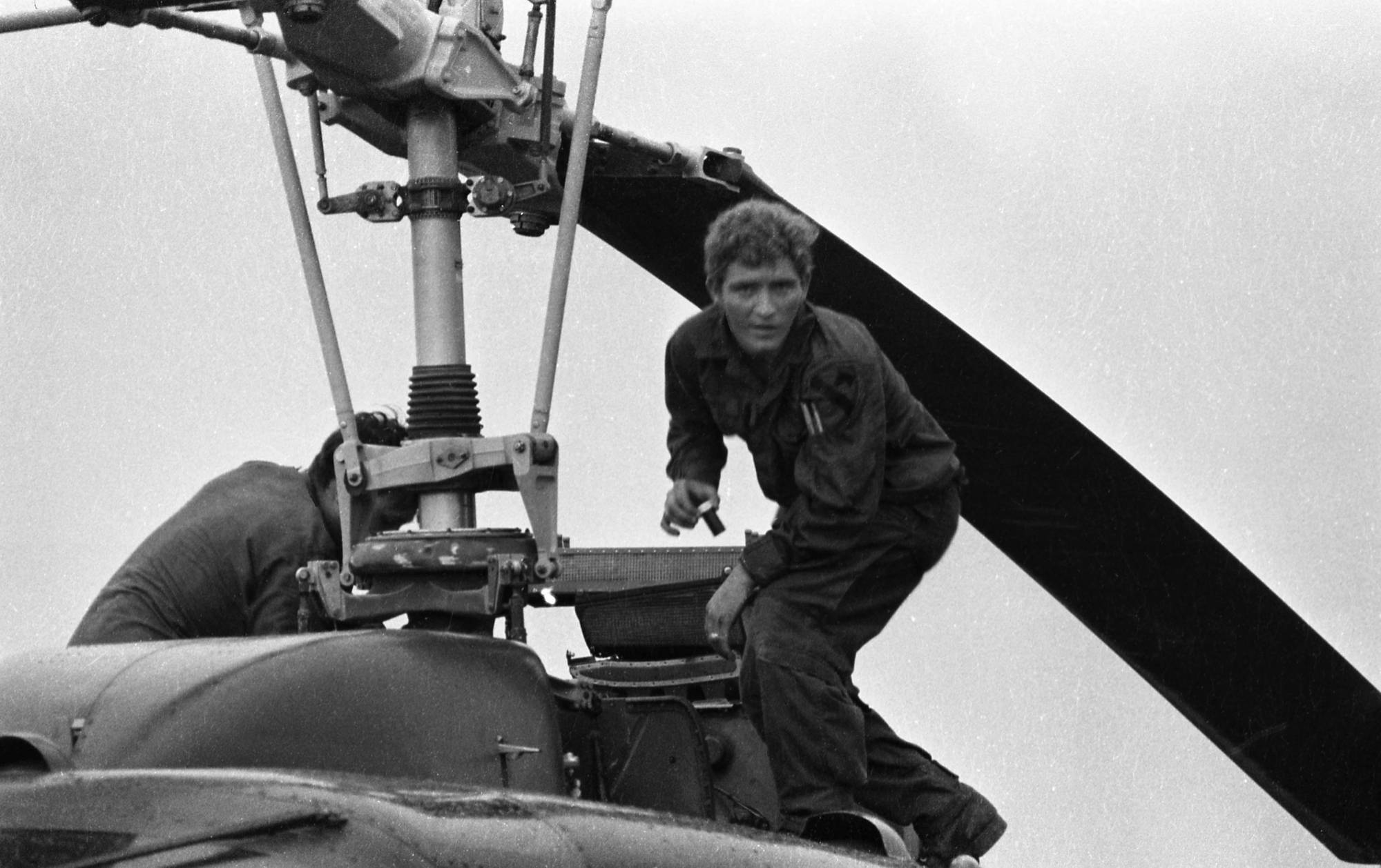 Soldier repairing helicopter blades.