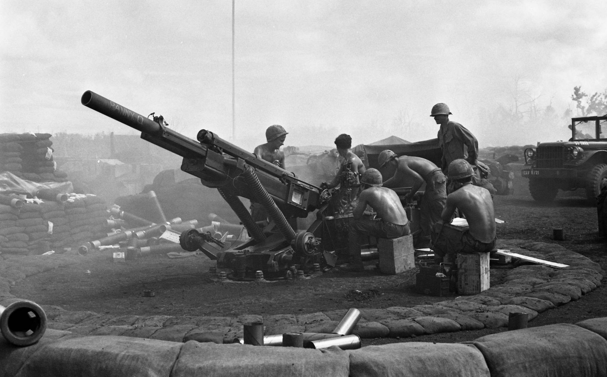 A group of men gathered around a cannon.