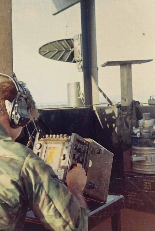 U.S. soldier operating a small machine, headset on.