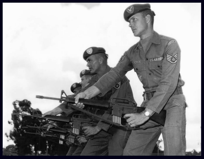 Air Force soldiers in formation, aiming their rifles.