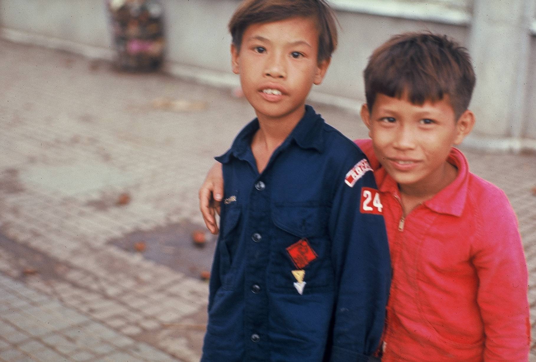 Two young Vietnamese boys, one in a Cub Scout shirt.