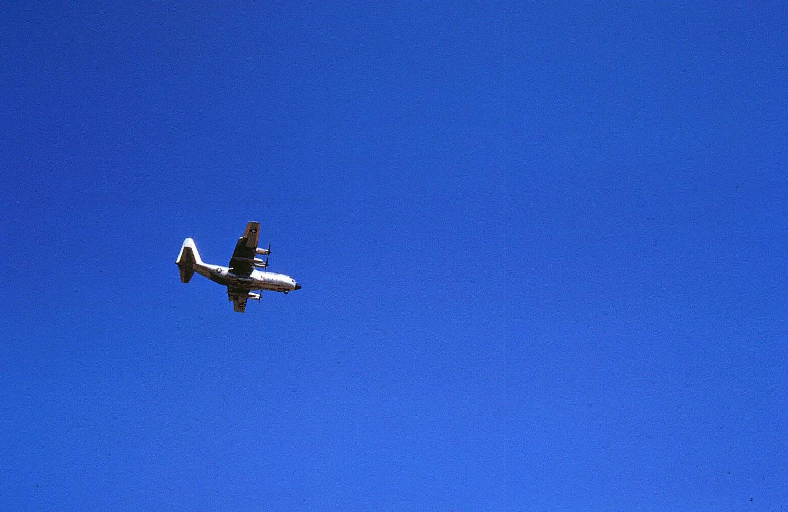 A plane against a bright blue, cloudless sky.