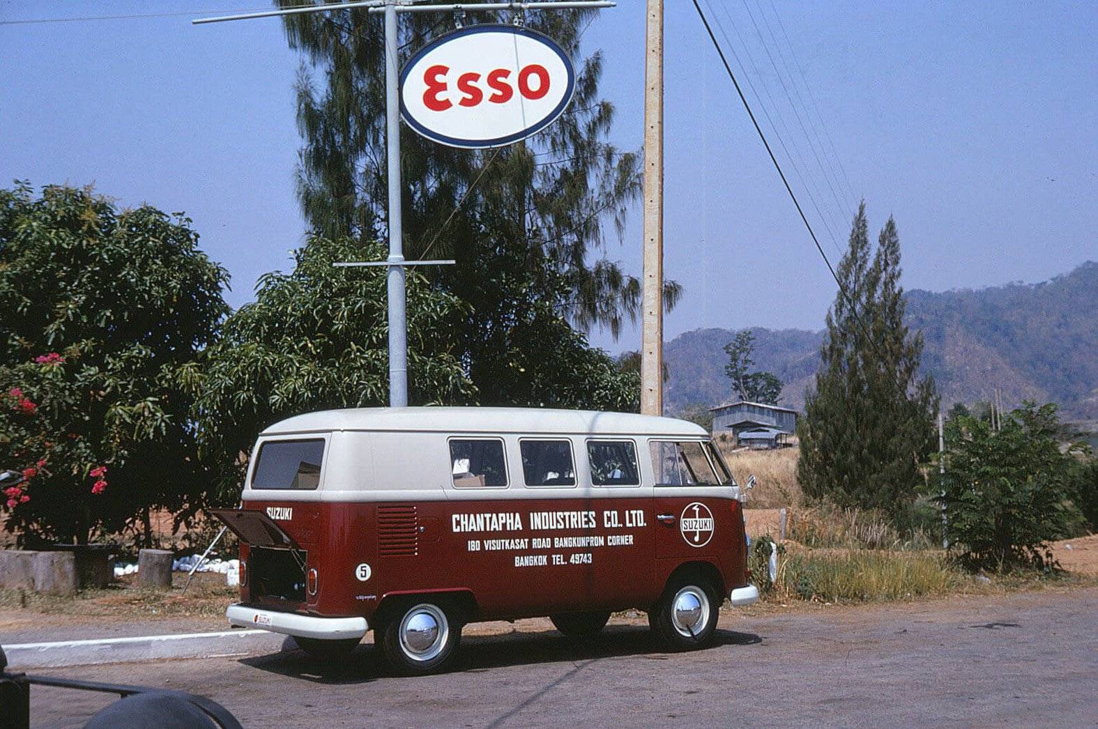A small van with "Chantapha Industries Co. Ltd." painted on the side; parked under an "Esso" sign.