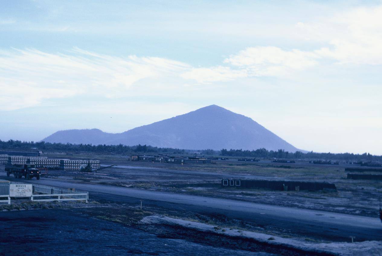 Landscape photo of fields and a mountain.