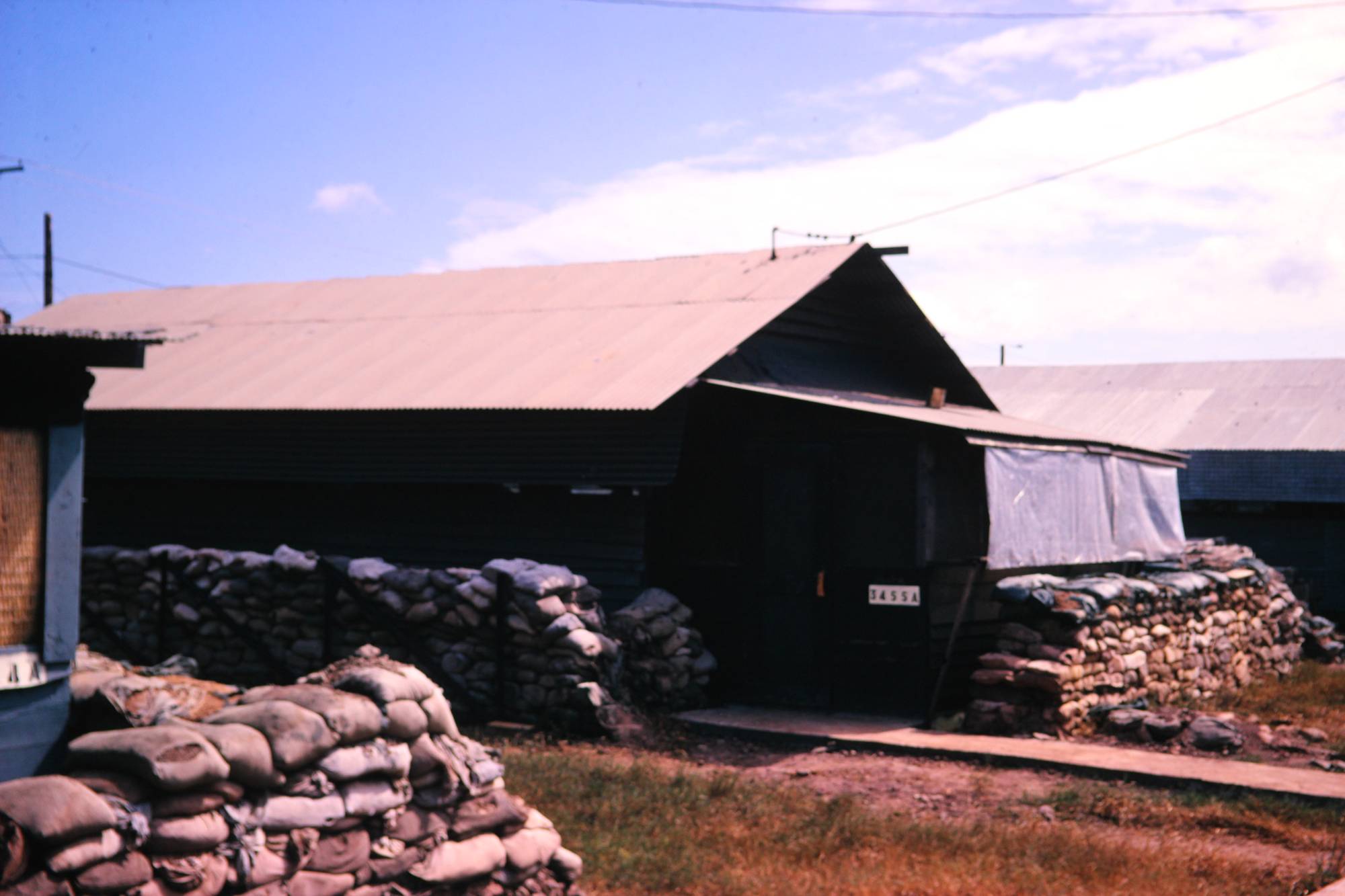 An encampment with sandbags lines up along the exterior walls of the buildings.