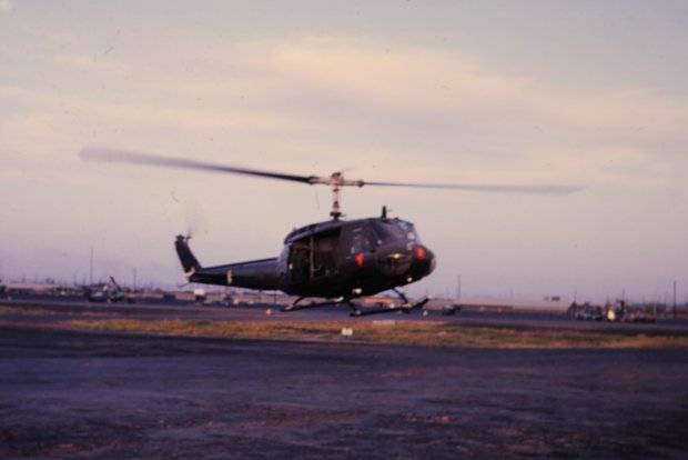 A helicopter close to the ground, taking off.