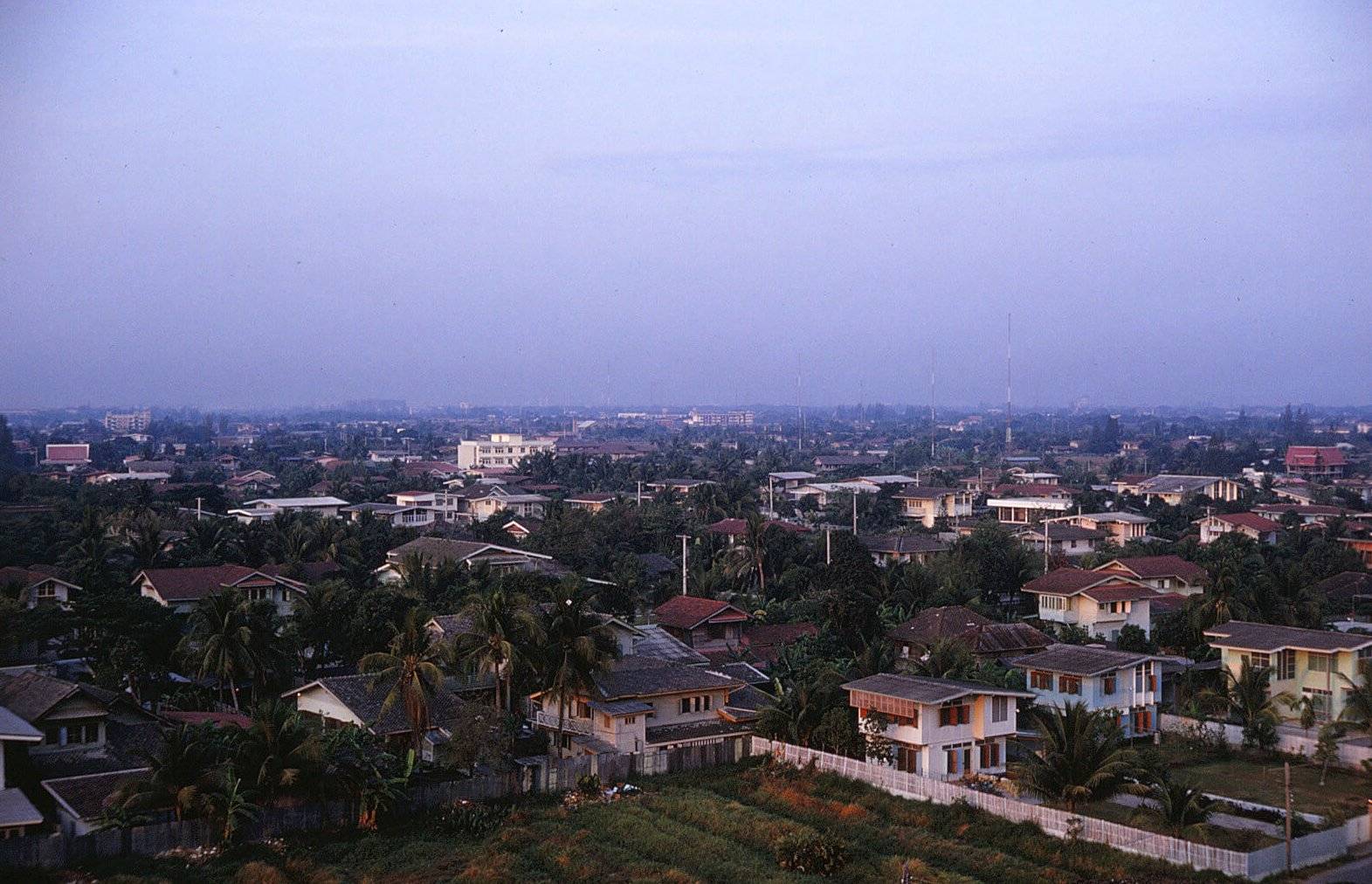 A landscape taken from up high of what looks to be suburbs of Thailand.