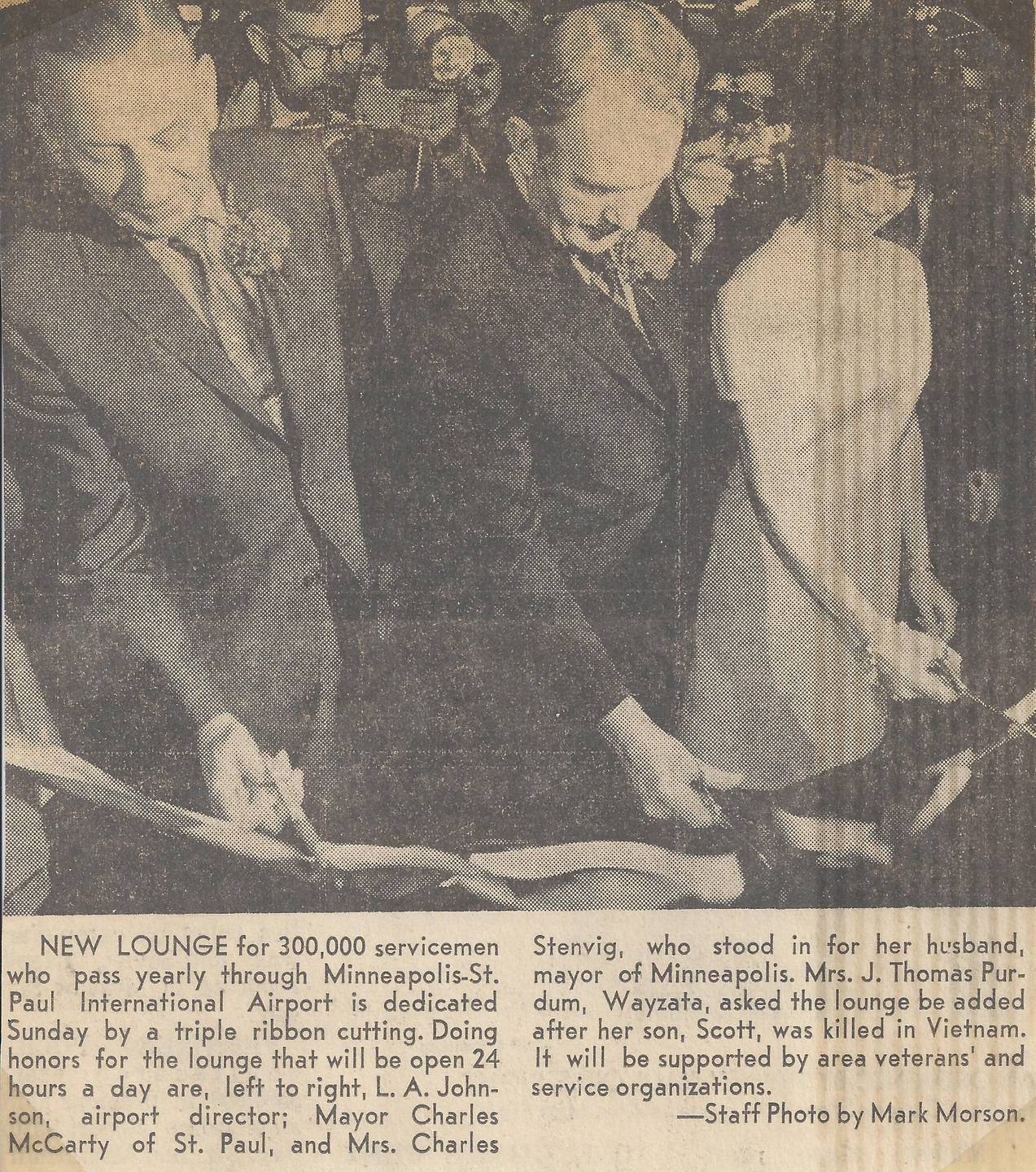 A news clipping that features three people wielding scissors, cutting a ribbon.