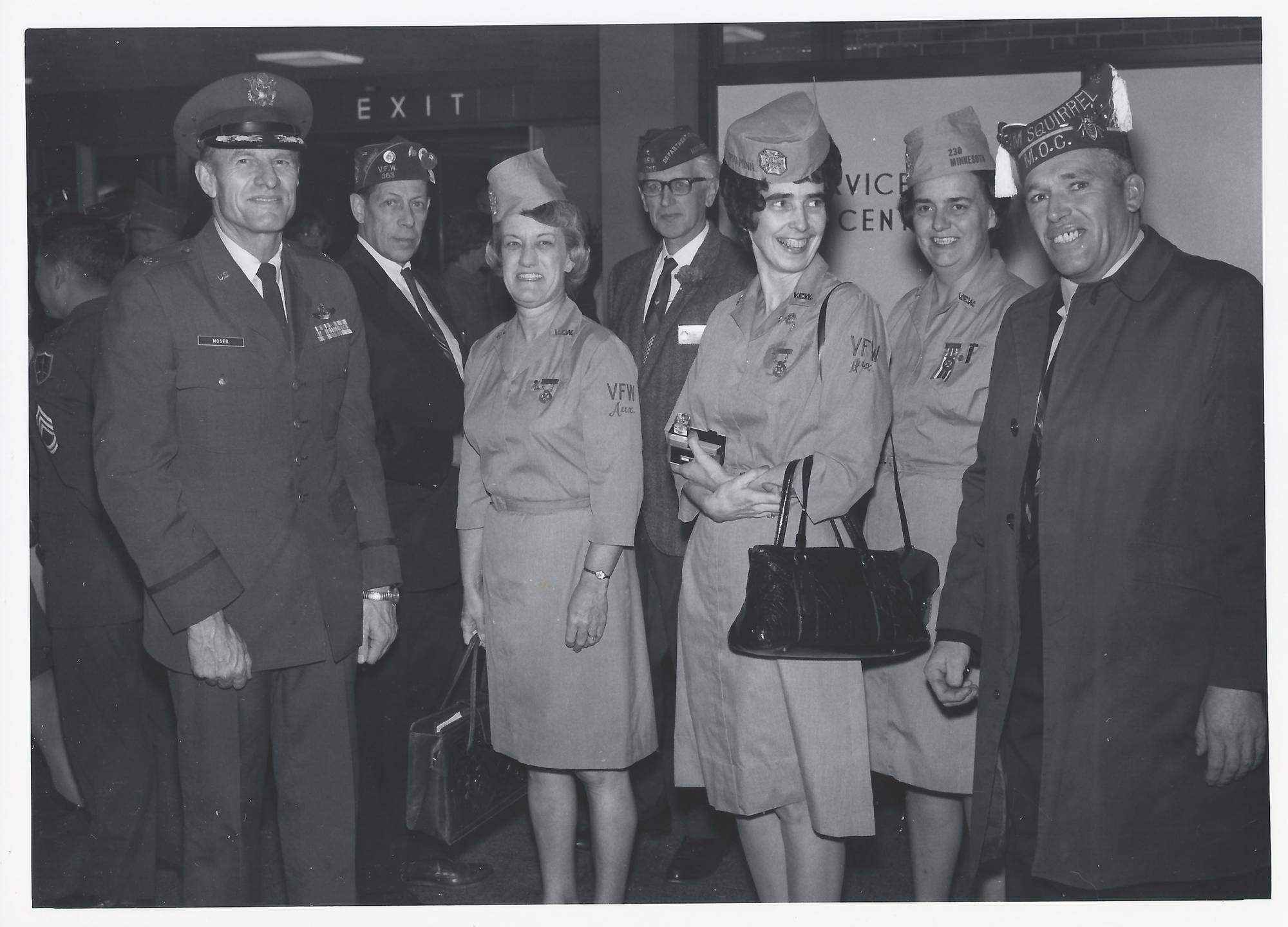 Older servicemen and servicewomen smiling for the camera.