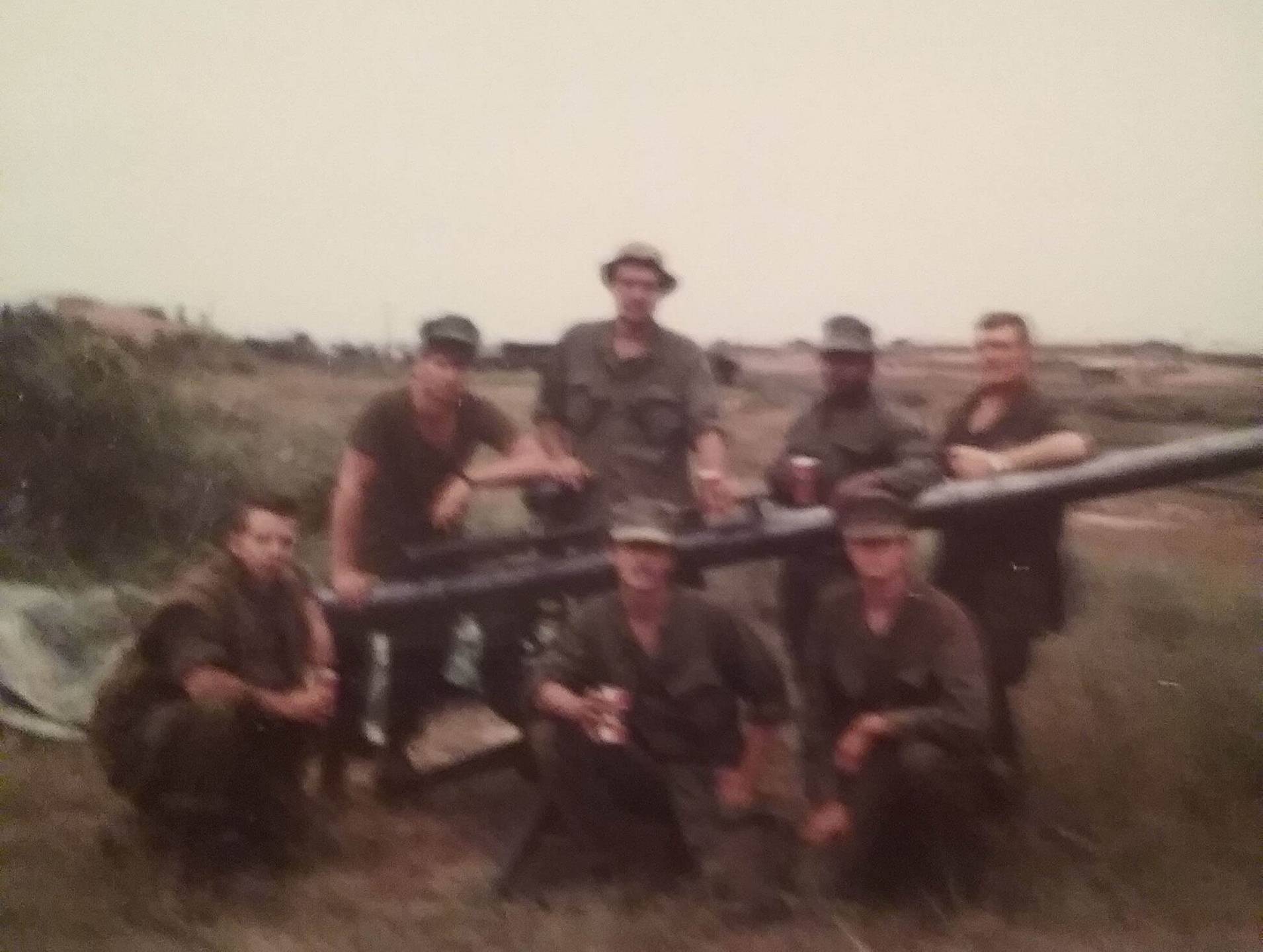 Group of U.S. soldiers with a very large rifle.