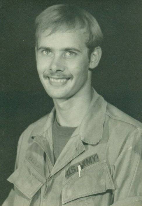 A portrait of a young, mustachioed soldier.