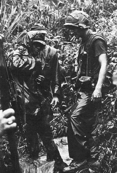 A small group of U.S. soldiers in the jungle.
