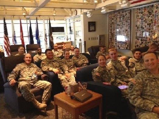 Contemporary photo of servicemen and women in the lounge.