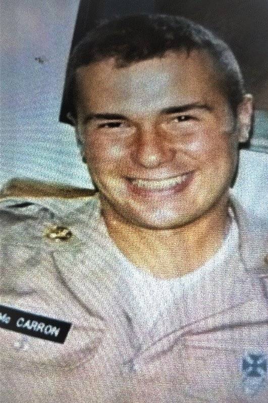 Young U.S. soldier smiling, nameplate reads "Mc CARRON".