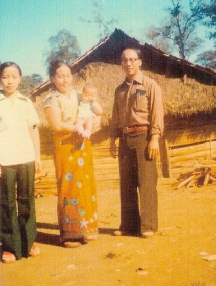 Asian family of four in a village.