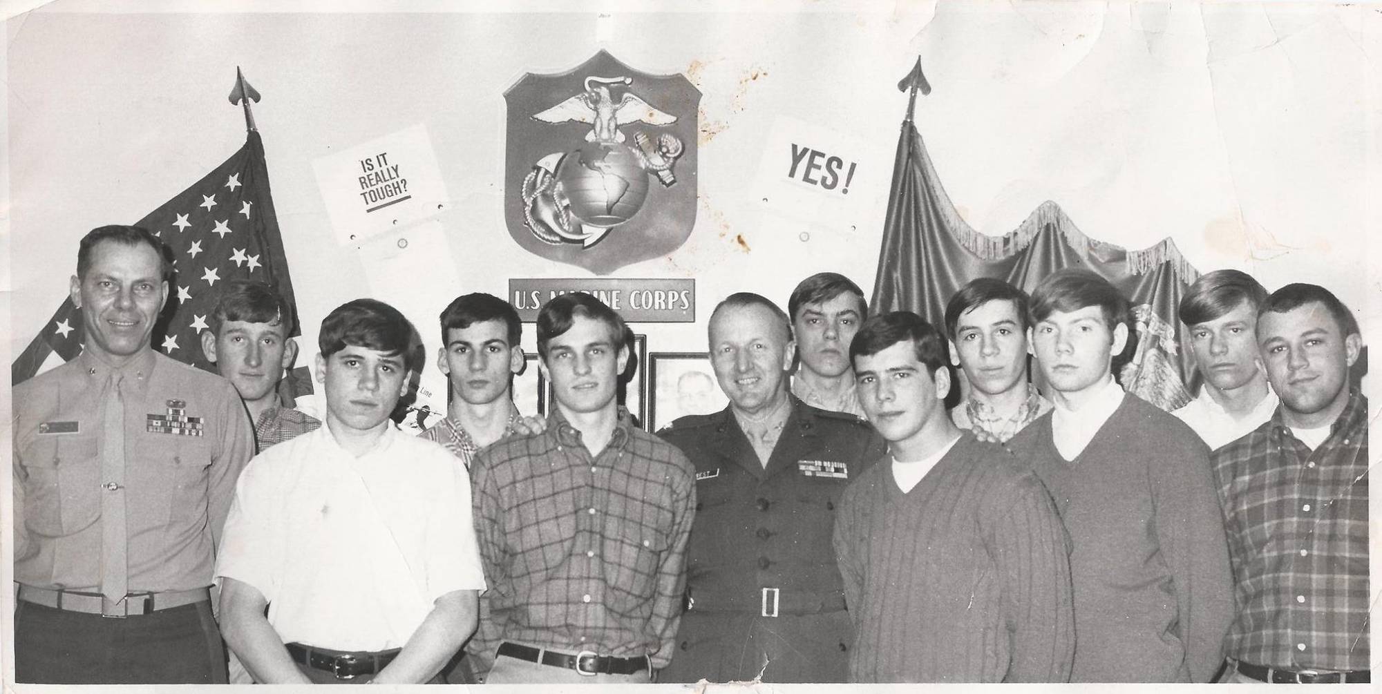 High school boys standing with Marine recruiters.