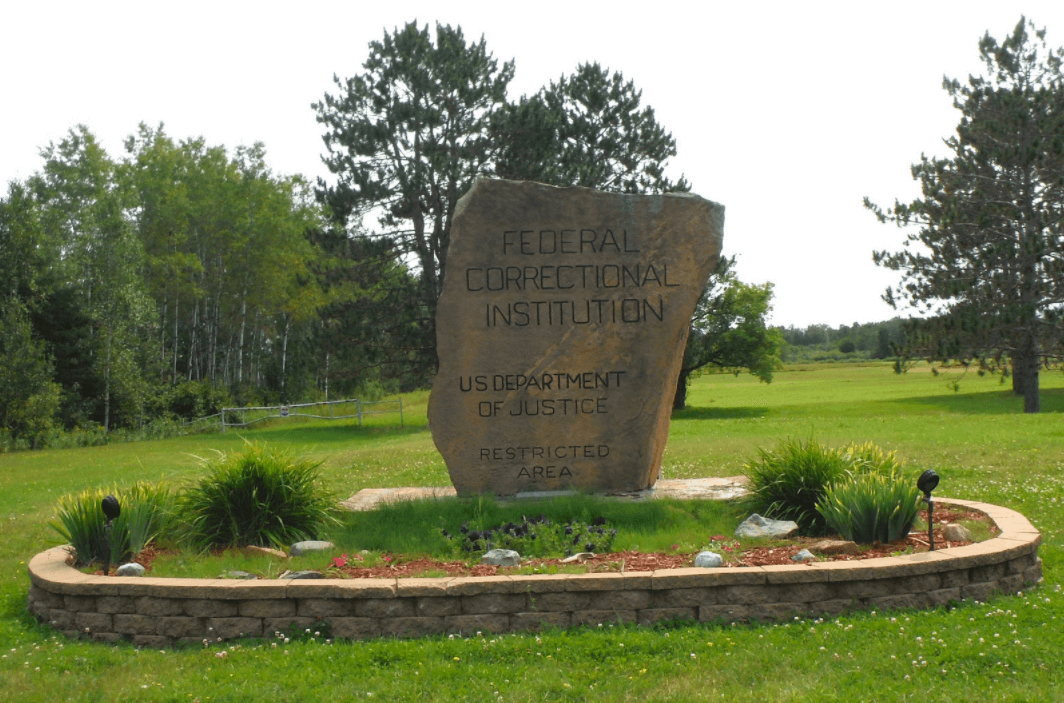 Signage for the Sandstone Federal Correctional Institution.