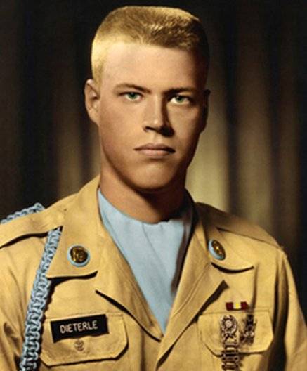 Official military portrait, colorized, of a young U.S. soldier.