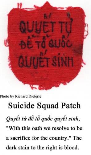 A red patch with Vietnamese text on it. Text under the patch reads: "With this oath we resolve to be a sacrifice for the country."