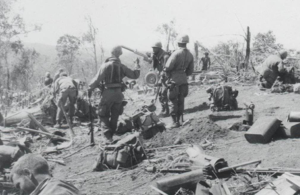 Soldiers and gear strewn about a hill side.