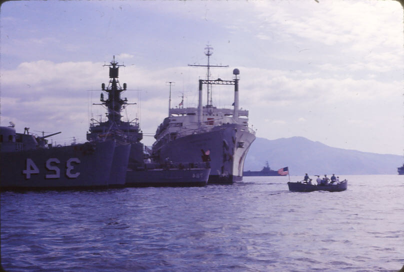 A large ship and several smaller ships on the water.