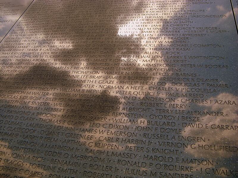 Reflection of a bright, cloudy sky in the Vietnam War Memorial.