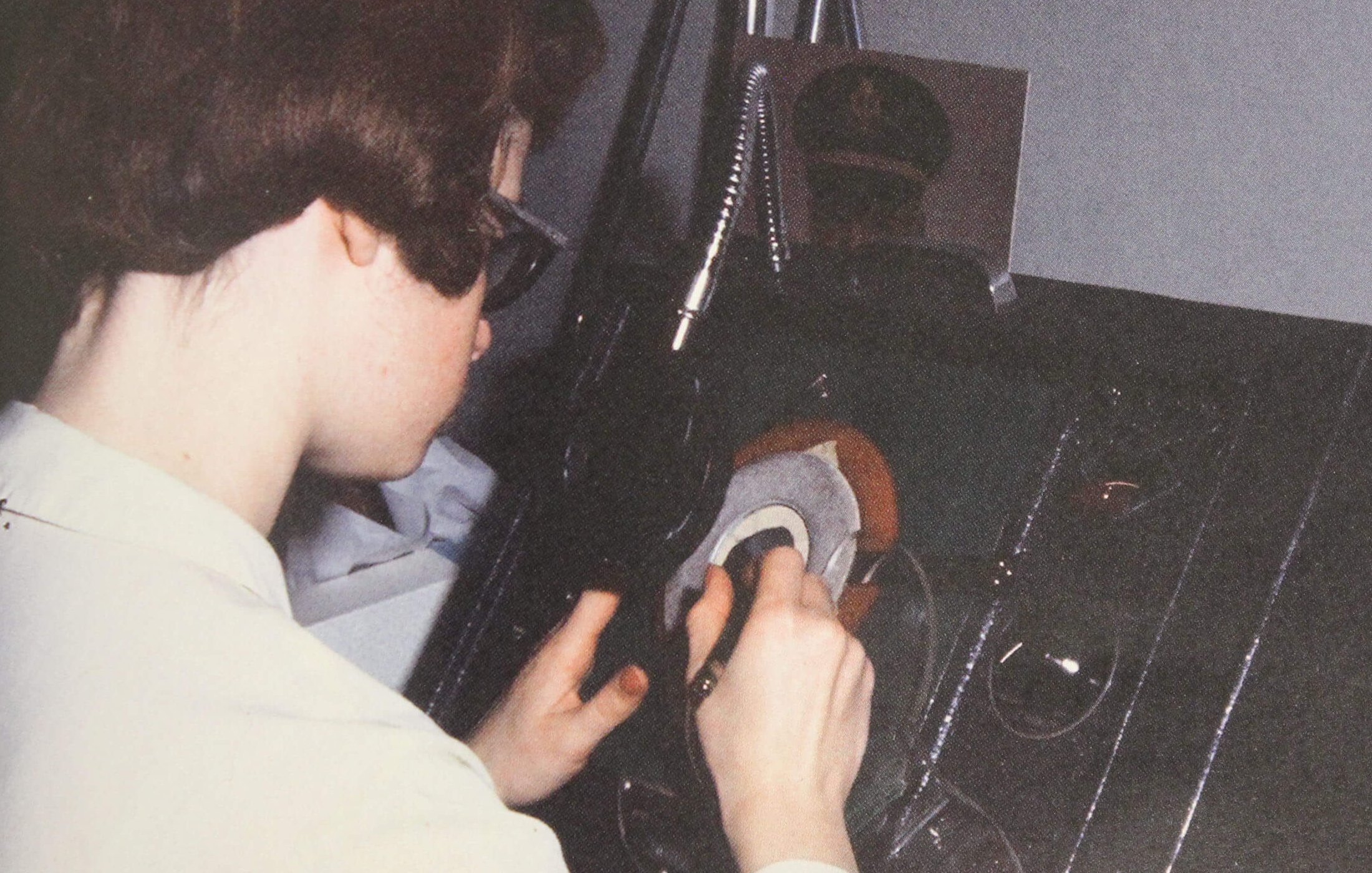 A young woman over some photography equipment, editing photos.