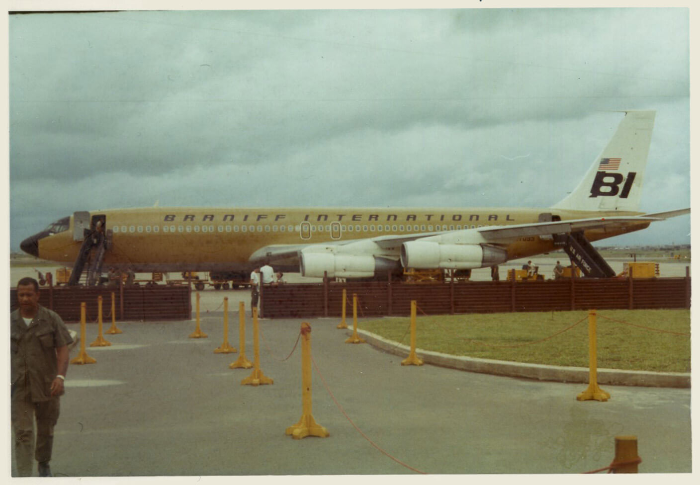 A large airplane on a runway, text on plane says "Braniff International."